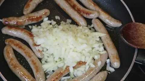 Cooking: Adding chopped onions to Sausage casserole Video stock 278348165