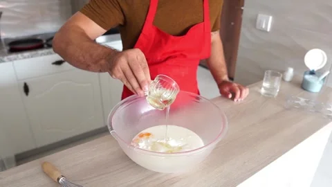 Cooking: Adding oil to a cookie mixture, pancake, crepe Stock Footage 219614353