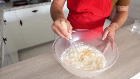 Cooking: Adding oil to a pancake batter mixture Stock Footage 219614352