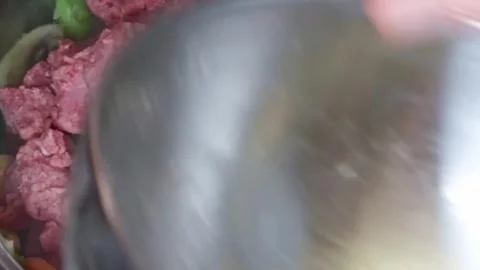 Cooking: Adding stewing steak to casserole Stock Footage 278348152