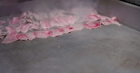 Cooking and chopping an authentic Philly Cheesesteak on a restaurant griddle Stock Footage 85032159