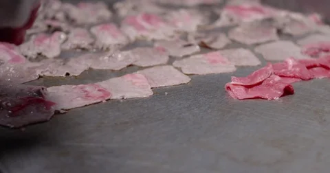Cooking and chopping an authentic Philly Cheesesteak on a restaurant griddle Stock Footage 85034478