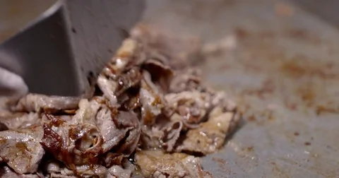 Cooking and chopping an authentic Philly Cheesesteak on a restaurant griddle Stock Footage 85041068