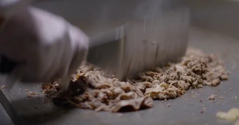 Cooking and chopping an authentic Philly Cheesesteak on a restaurant griddle Stock Footage