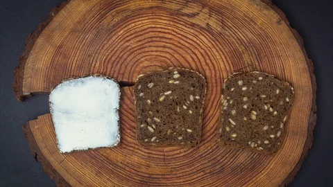 Cooking and eating three different toasts with cream cheese, tomatoes, eggs Stock Footage 129174233