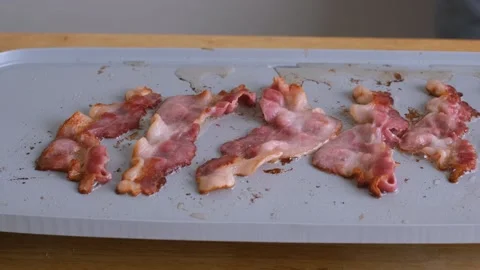 Cooking and flipping bacon on a griddle. Видео 138339624
