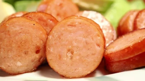 Cooking and serving sliced sausage in a kitchen Stock Footage 342487674