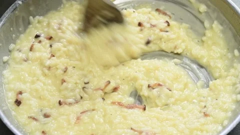 Cooking and stirring risotto alla carbonara in a frying pan. Stock Footage 170903380