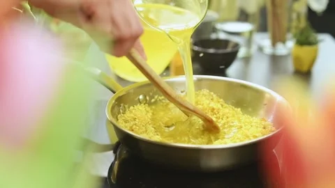 Cooking and stirring risotto in the frying pan. Stock Footage 162057843