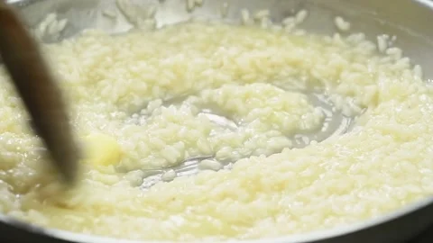 Cooking and stirring risotto in a frying pan. Stock Footage 170903368