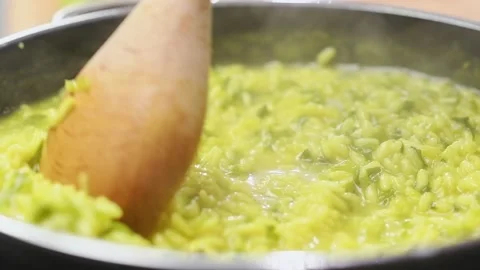 Cooking and stirring risotto with vegetables in the pan. Stock Footage 150828650