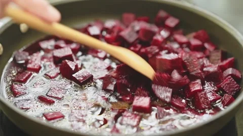 Cooking and stirring of sliced beetroot in a pan with olive oil and water. Stock Footage 151689571
