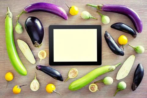 Cooking and technology. Tablet computer with collection of fresh colorful egg Stock Photos