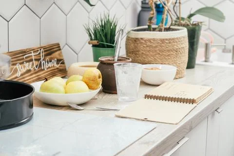 Cooking of apple pie in kitchen. Kitchen countertop with ingredients, cooking Stock Photos