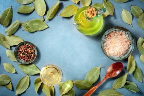 Cooking background with copy space. Salt, pepper, bay leaves, olive oil and Fotos Stock