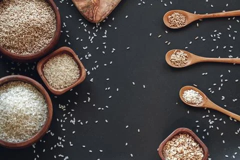 Cooking background of different types of rice and cereals in woo Stock Photos
