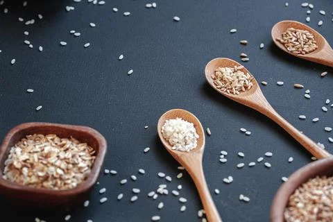 Cooking background of different types of rice and cereals in woo Stock Photos