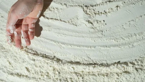 The cooking background is drawn by the hand over the wheat flour, top view Stock Footage 293466186