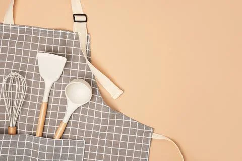 Cooking background. Flat kitchen accessories. Apron and silicone cooking uten Stock Photos