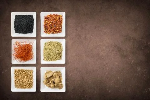 Cooking background with plates with different types of spices. Asian spices l Stock Photos