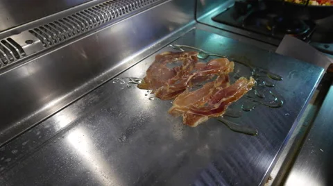 Cooking bacon and eggs Stock Footage 64710992