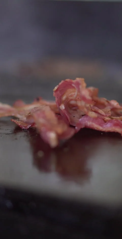 Cooking Bacon on a griddle Stock Footage 240873622