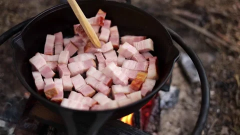 Cooking Bacon Over Campfire in Cast Iron Stock-Footage 280121567