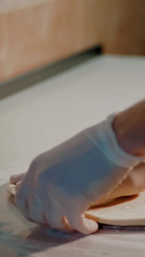Cooking, bakery . close-up. the chef rolls out pizza dough blank on the Stock-Footage 321533611