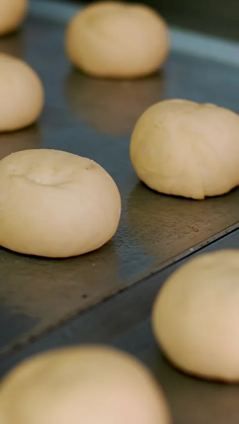 Cooking. bakery products. close-up. blanks of raw yeast dough for buns lie on a Stock-Footage 323088140