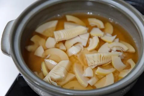 Cooking bamboo shoot rice in an earthenware pot Stock Photos