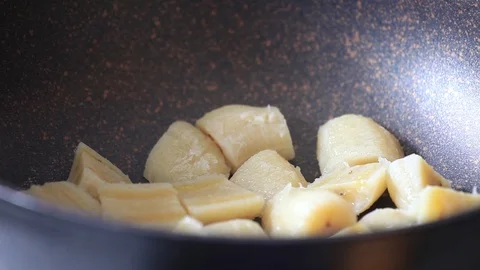 Cooking bananas : adding sugar to bananas in a pan Stock Footage