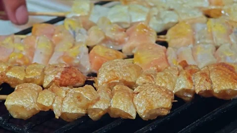Cooking BBQ Salmon. Hands turn pieces of salmon stick on the grill. Stock Footage 304599985