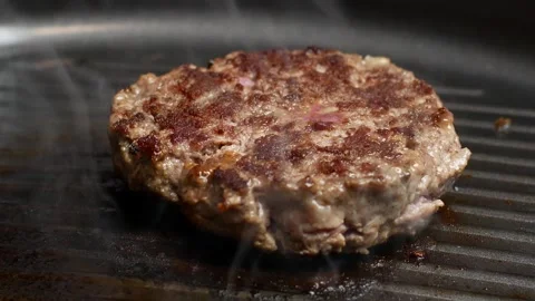 Cooking beef cutlets. the chef turns the cutlet, close-up Stock Footage 196848239