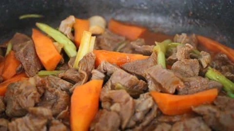 Cooking beef meat and vegetables , beef stew with carrot and leek, close up Stock Footage 174081339