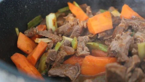 Cooking beef meat and vegetables , beef stew with carrot and leek, close up Stock Footage 174081340
