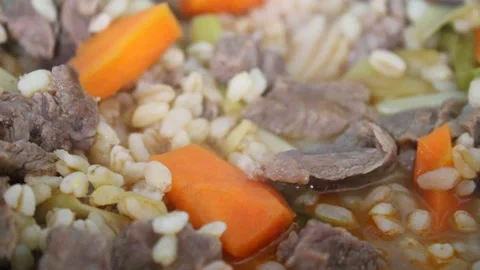Cooking beef meat and vegetables , carrot, leek and wheat, beef stew Stock Footage 174081394