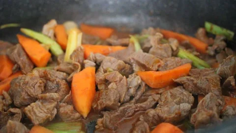 Cooking beef meat and vegetables , beef stew with carrot and leek, close up view Stock-Footage 180449710