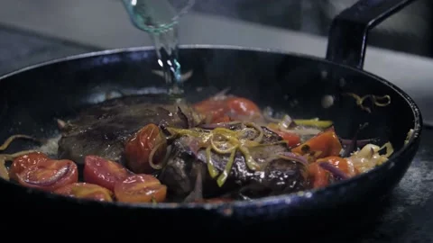 Cooking Beef meat Stroganoff with Open Flames. Chef making steak in flambe style Stock Footage 141110028
