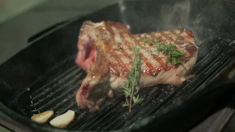 Cooking beef steak. One beef fillet meat is being fried in a grill pan. Stock-Footage 106262419