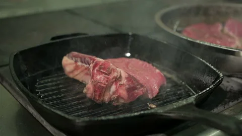 Cooking beef steak. One beef fillet meat is being fried in a grill pan. Stock-Footage 106264393