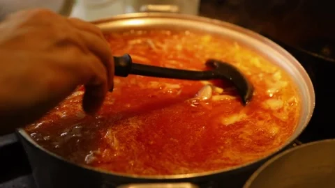 Cooking beet soup or borscht ukrainian traditional meal at domestic kitchen on a Stock Footage 149437848
