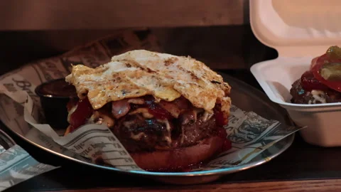 Cooking a big burger with a omelet Stock Footage 267614784