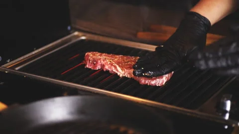 Cooking a big steak on B-B-Q. A piece of pork on the barbecue grill Stock Footage 102870341