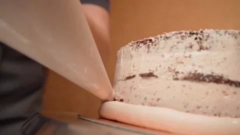 Cooking a biscuit cake. Apply the cream on board the cake Stock Footage 155281096