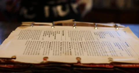 Cooking book flipping through pages looking for a recipe to bake Video stock 217356858