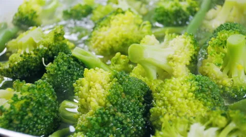 Cooking broccoli and green beans in a frying pan. Close up. Stock Footage 57532566