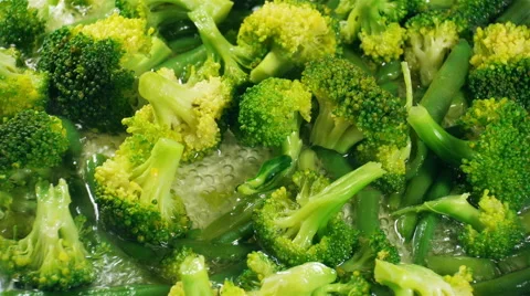 Cooking broccoli and green beans in a frying pan. Close up. Stock Footage 57533510