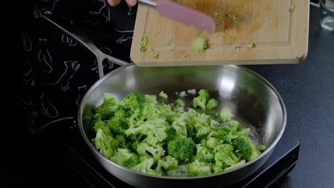 Cooking Broccoli in a Frying Pan with Spatula in Kitchen Video stock 341420593