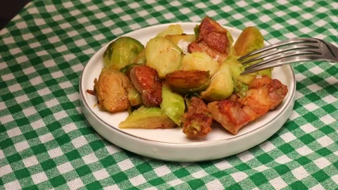 Cooking Brussels sprouts with crispy bacon and grated Parmesan cheese Stock Footage 286353121