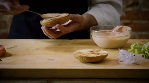 Cooking burger. Chef's hands preparing a tasty hamburger with beef rissole. 4K Stock Footage 82359901